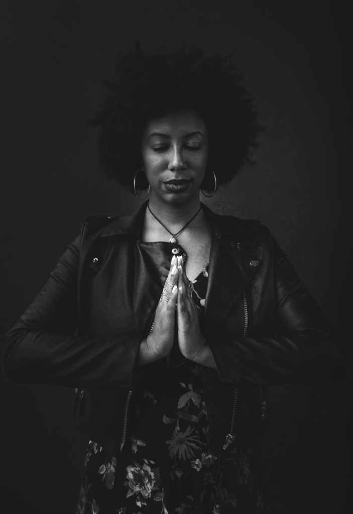 woman with Afro standing in meditation 
